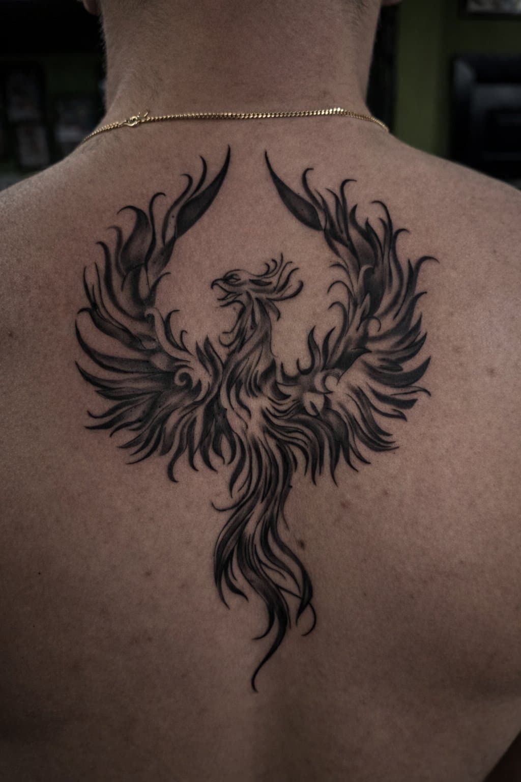 Black and grey phoenix back piece with feathered wings
