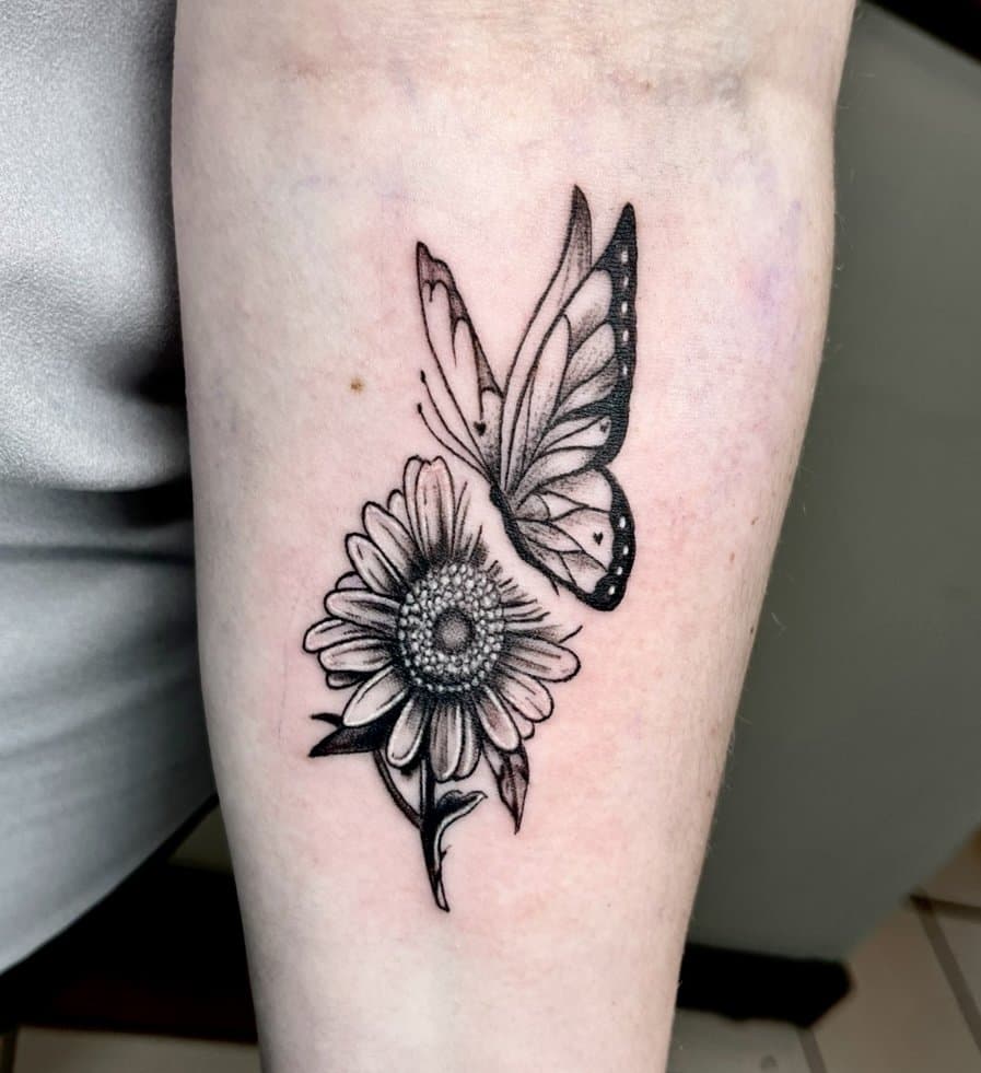 Fine-line butterfly and sunflower forearm tattoo