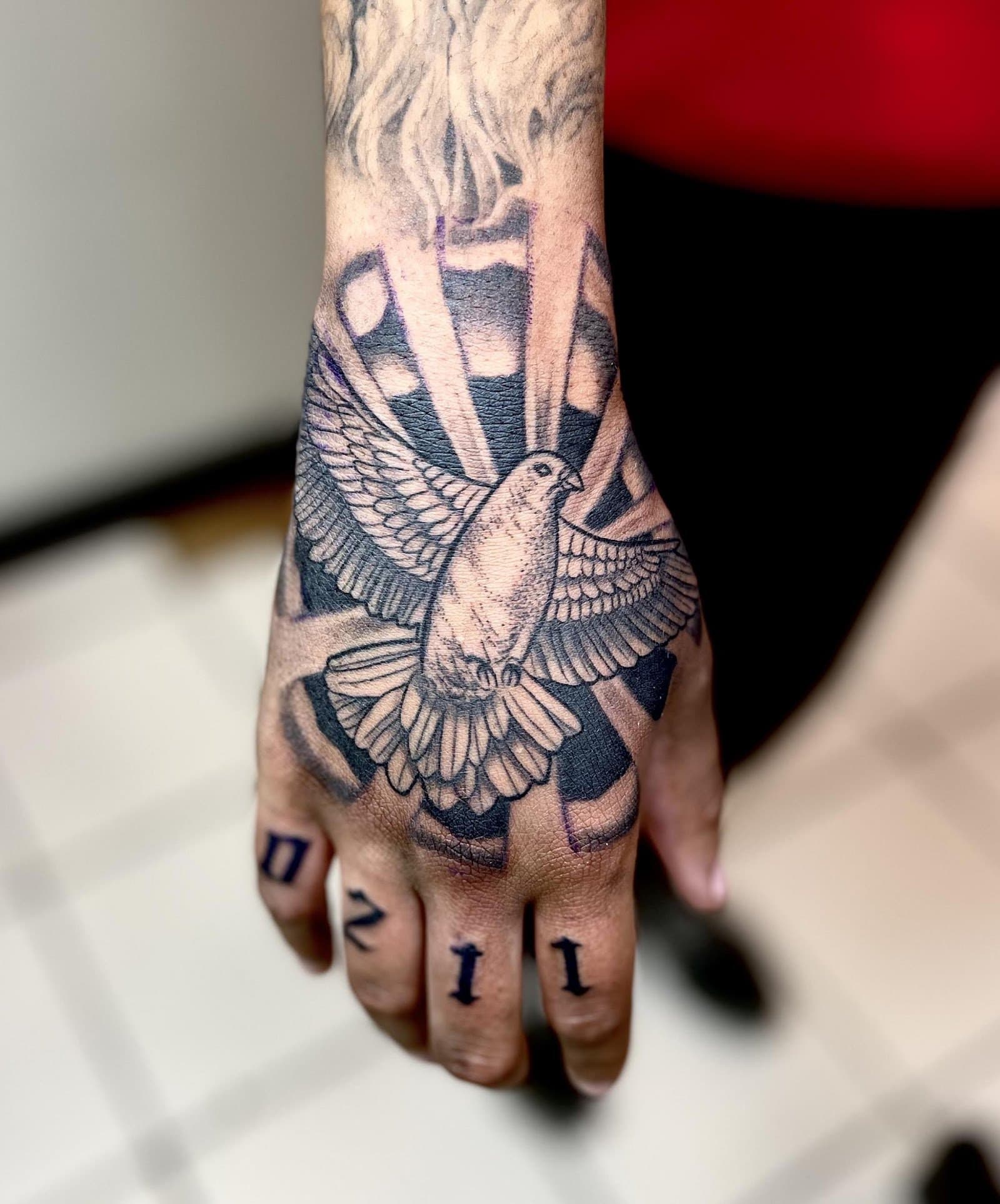 Blackwork dove hand tattoo