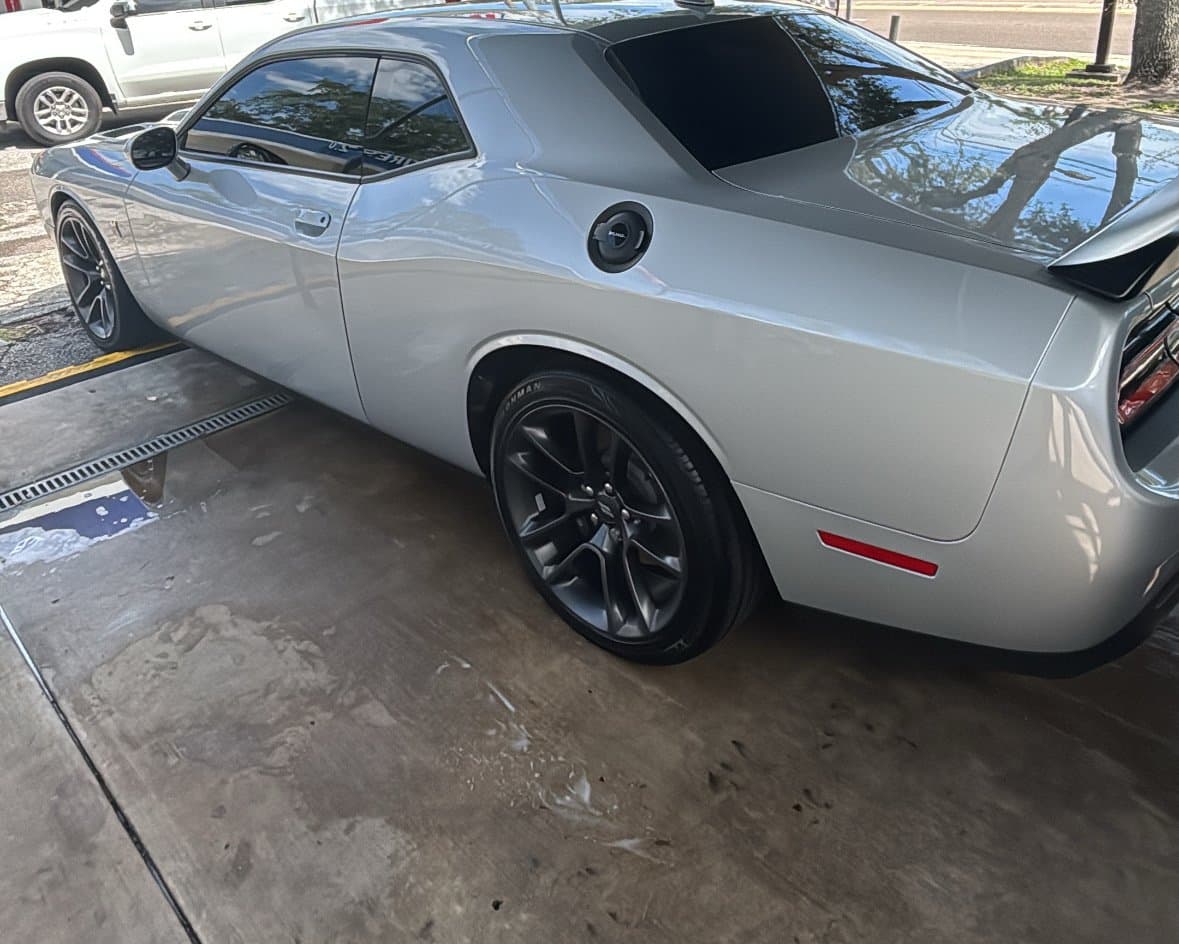 A silver Dodge Challenger with a mirror finish reflecting the sky after a spot-free rinse at Rock's Car Spa