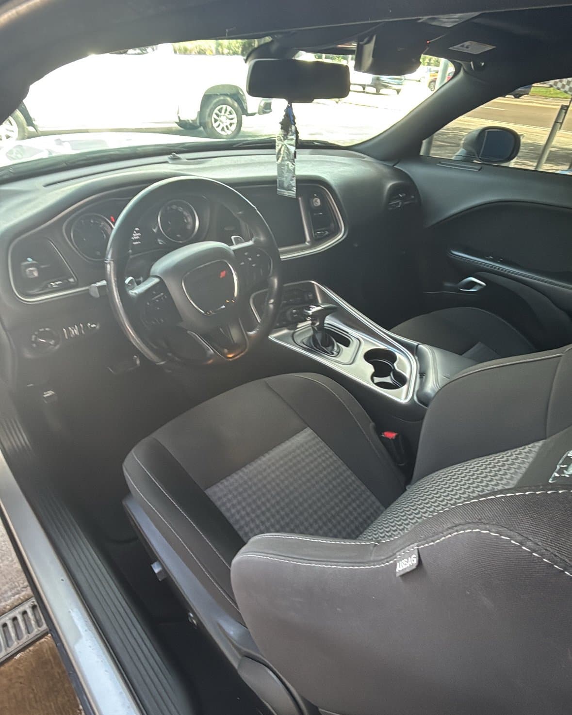 The cleaned interior of a Dodge Challenger after a wash at Rock's Car Spa — dash, console, and seats wiped down