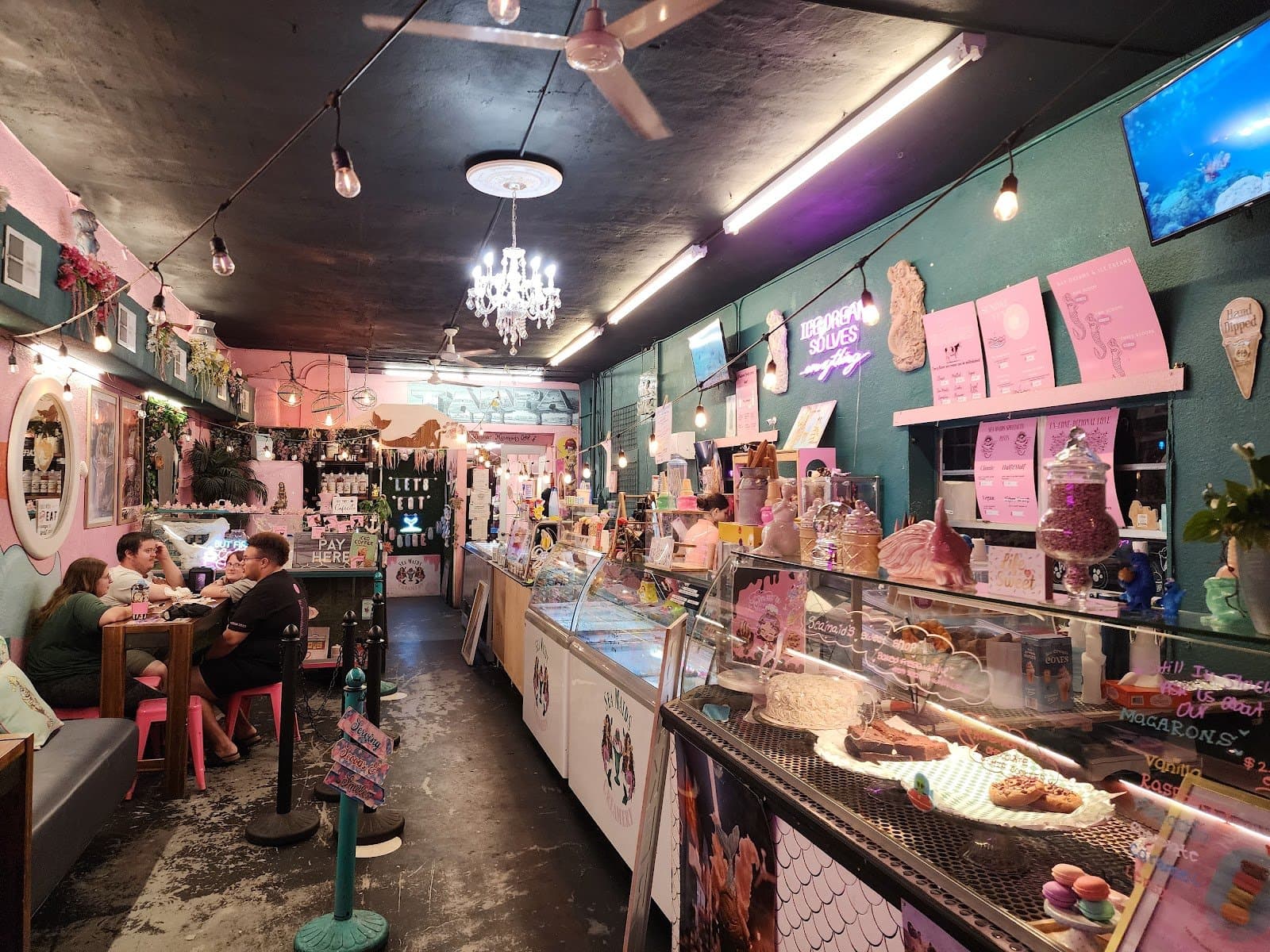 Pink parlor interior with chandelier at Sea Maids Creamery