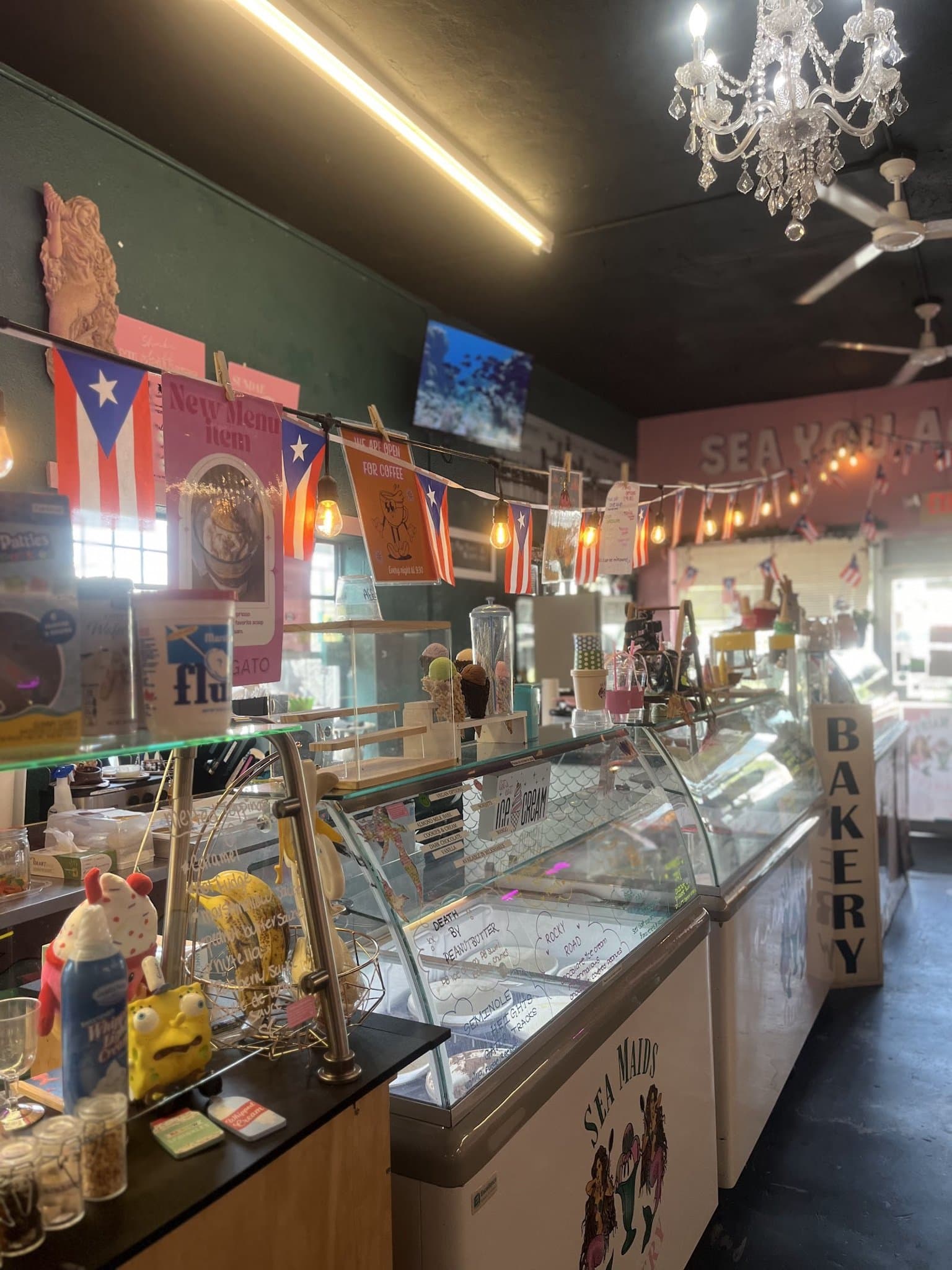 Inside Sea Maids Creamery with display counters and Puerto Rico flags