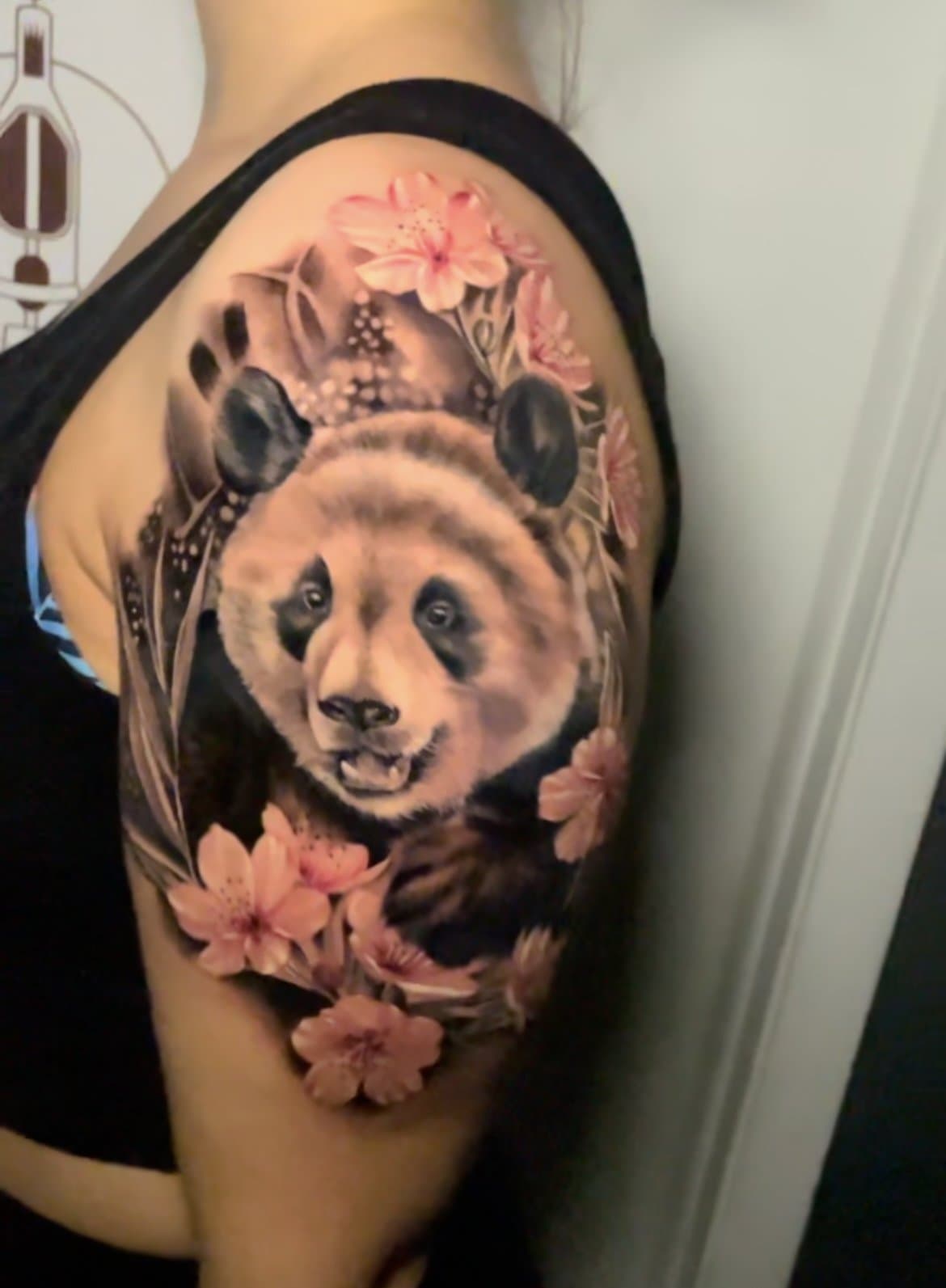 Color panda and cherry blossom shoulder tattoo