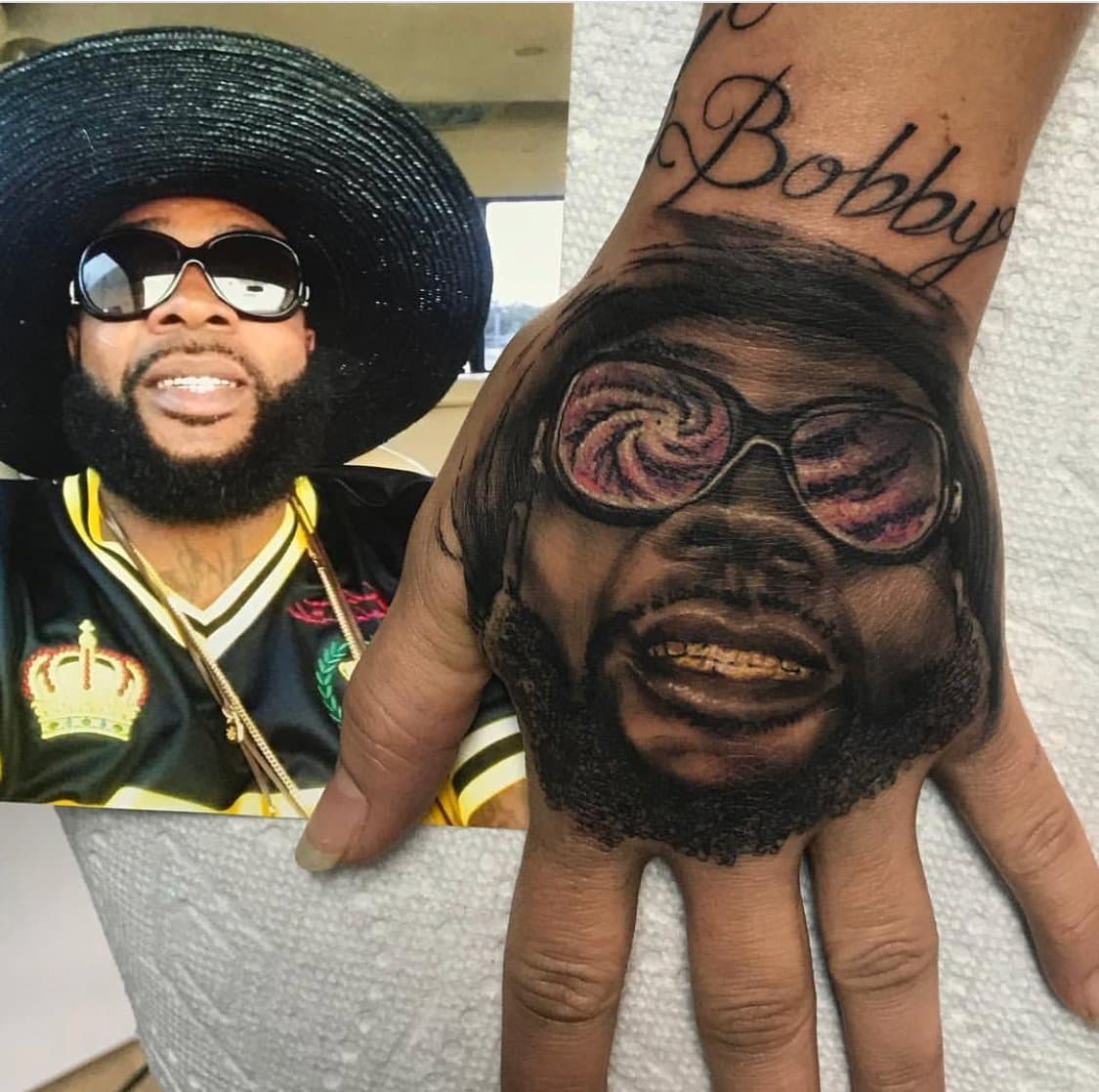 Photorealistic portrait hand tattoo next to the reference photo