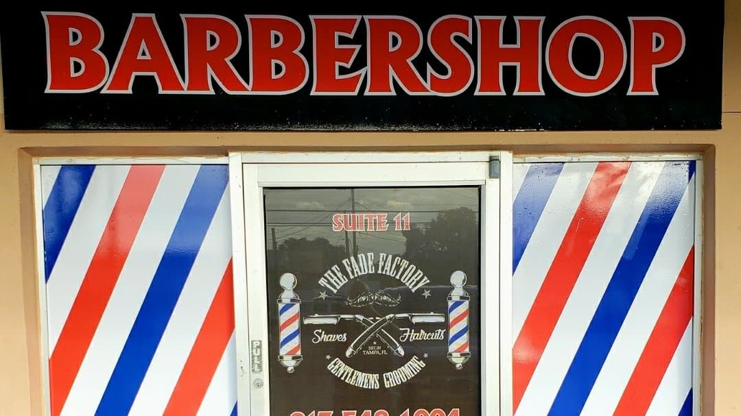 The Fade Factory storefront with barber pole stripes on N Lincoln Ave