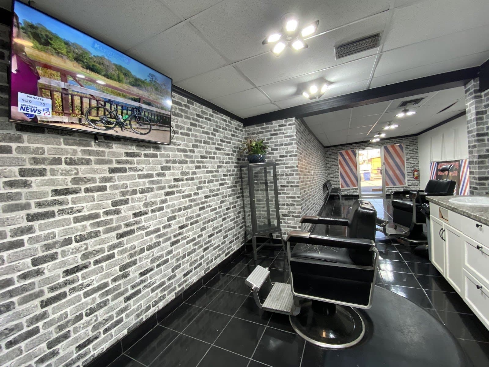Inside The Fade Factory — white brick walls and black barber chairs
