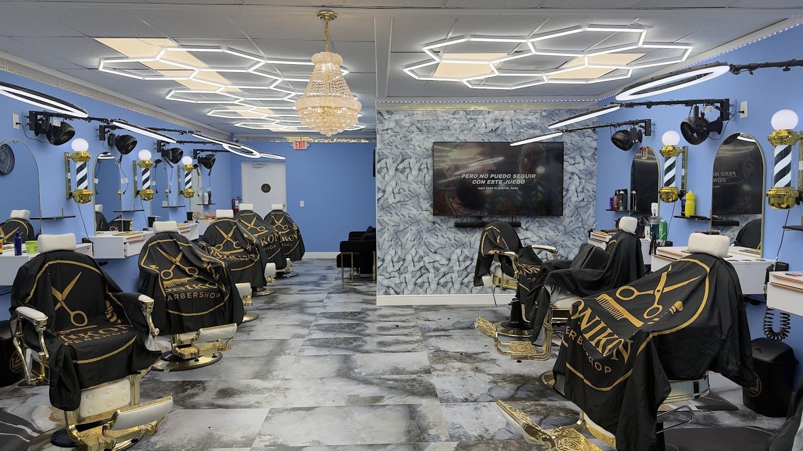 Inside Tonikon Barbershop — gold-crest chairs and chandelier