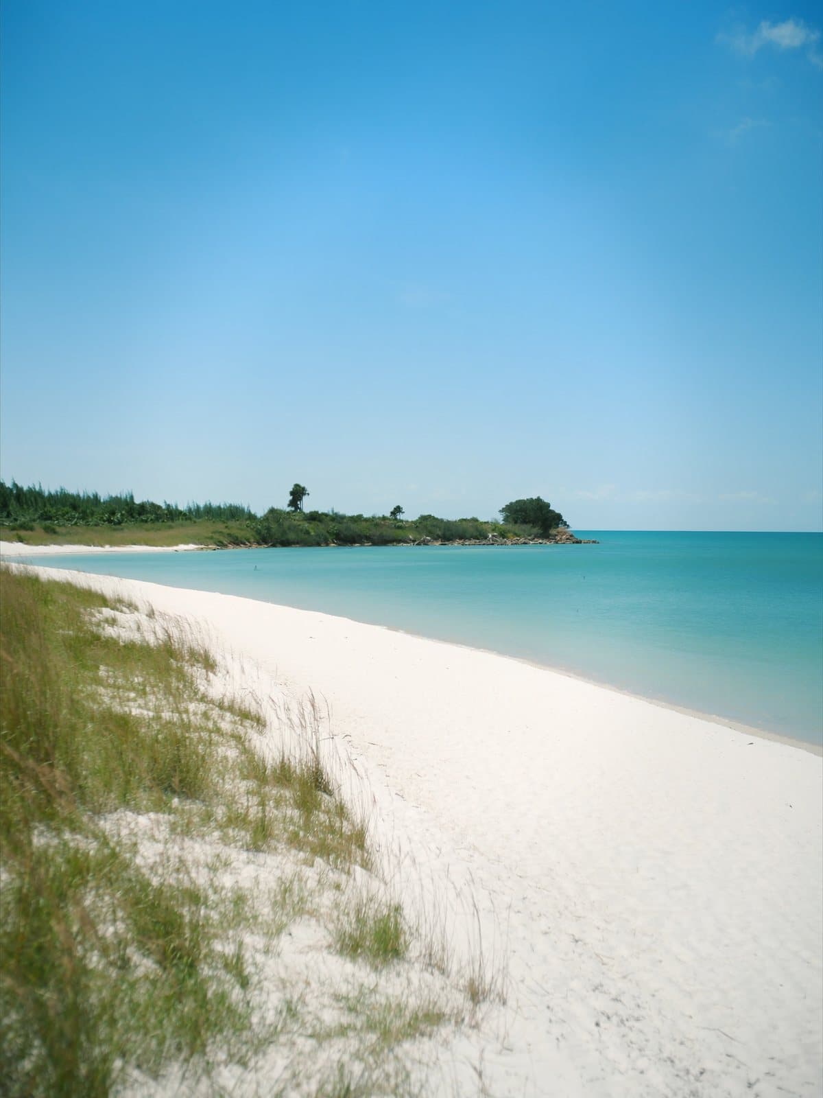 A secluded Gulf Coast island beach with white sand and turquoise water